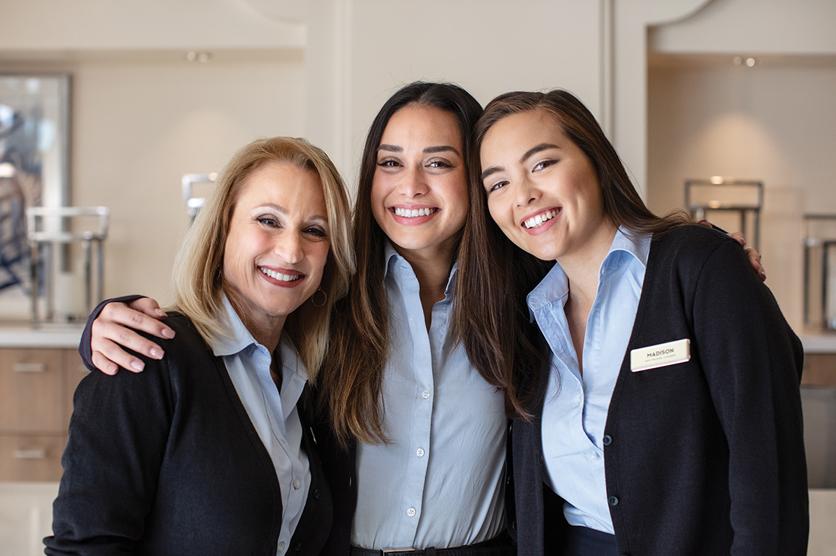 Groups of smiling Marriott associates standing side by side 