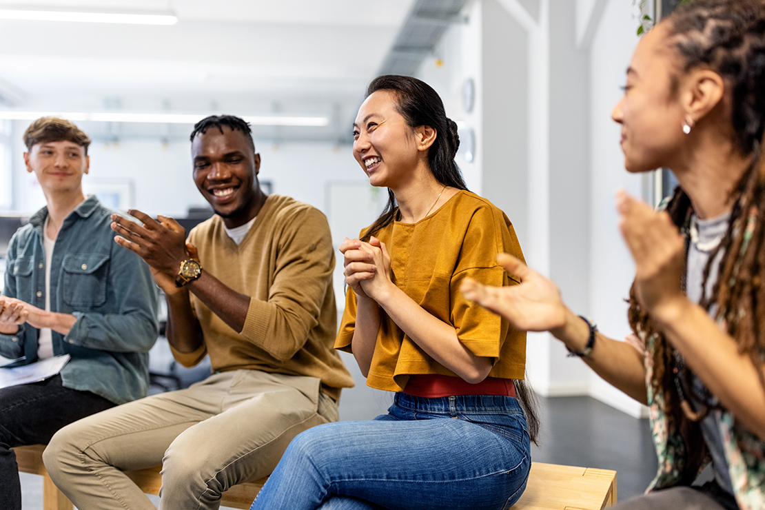 Group of diverse, smiling college students sitting together